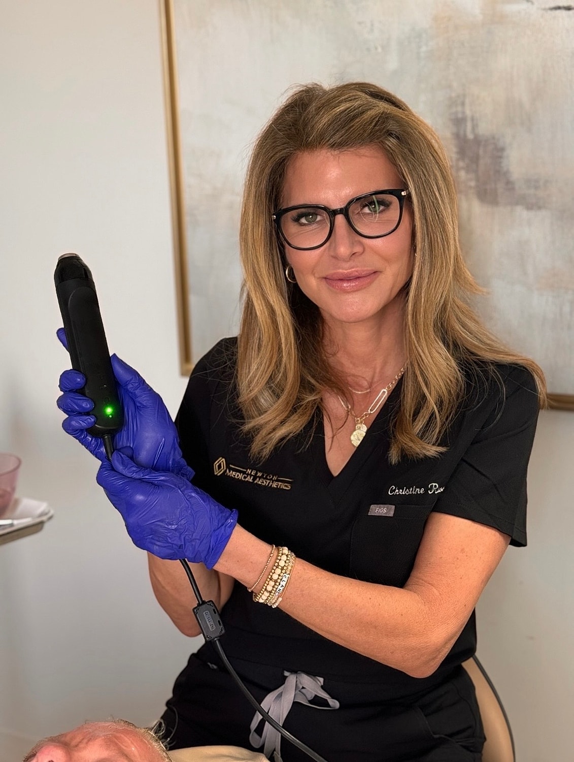 Medical professional using aesthetic treatment device.